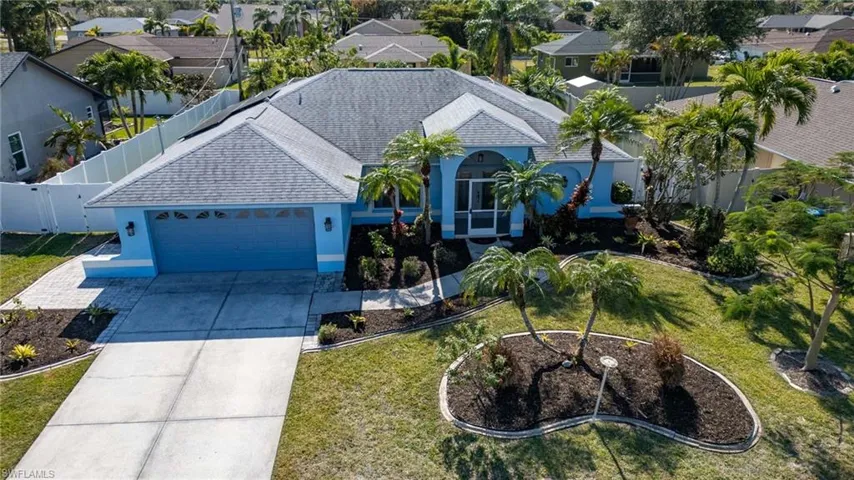Front of home showing 2 car garage and screened, double-door entry.