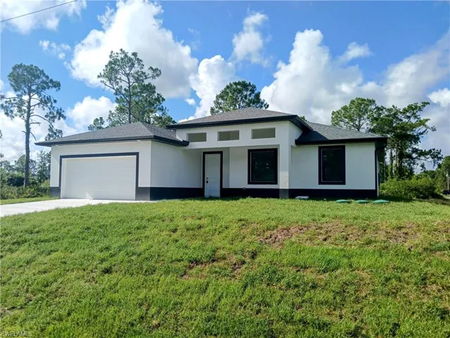 Prairie-style house featuring a garage and a front yard