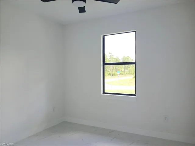 Empty room featuring ceiling fan