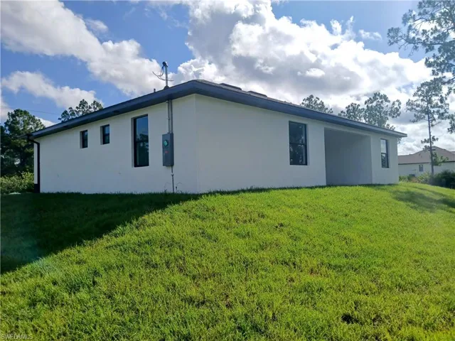 View of home's exterior with a lawn
