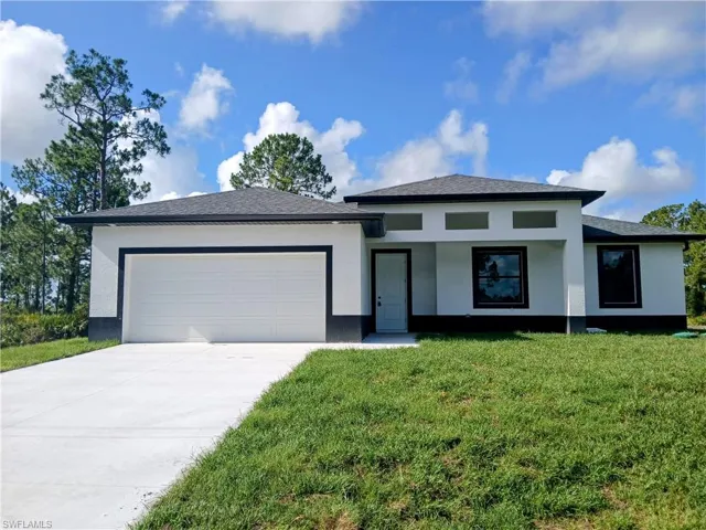 Prairie-style house featuring a garage and a front lawn