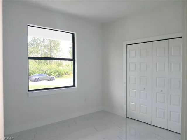 Unfurnished bedroom featuring tile patterned floors and a closet