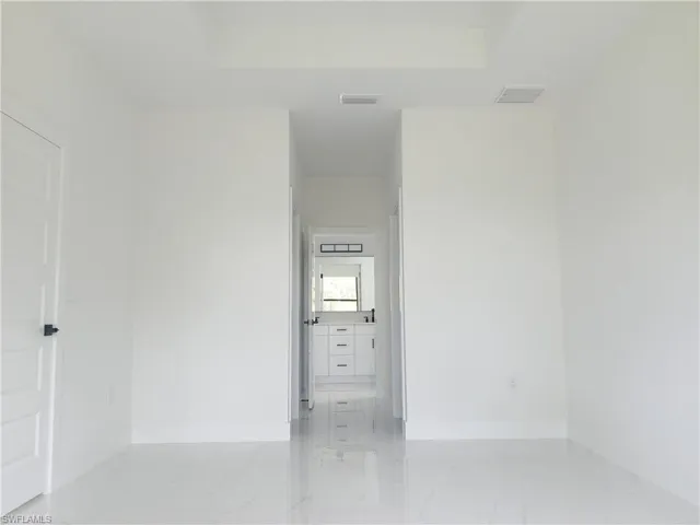 Empty room featuring light tile patterned floors