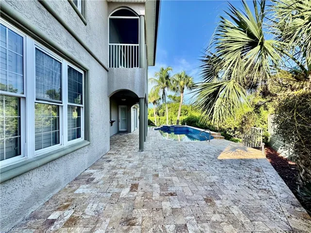 View of patio / terrace with a hot tub and an outdoor pool