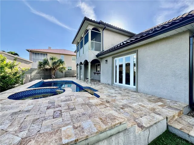 View of swimming pool featuring a patio, french doors, and a pool with connected hot tub