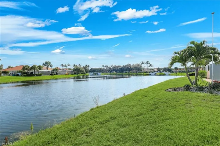 Expansive waterfront property featuring mature palm trees and established landscaping