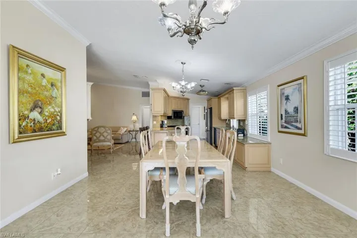 Polished tile flooring, crown molding, plantation shutters, and recessed lighting