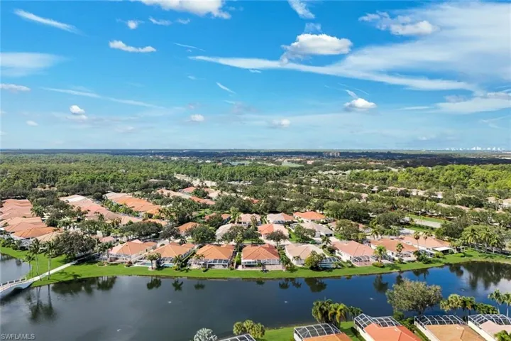 Waterfront community with extensive greenery and a bridge feature