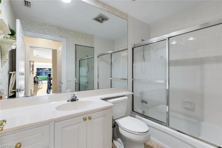 White vanity with double-door cabinetry, integrated sink, and chrome faucet