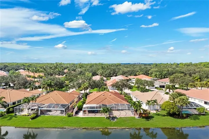 Waterfront community with lush landscaping and screened pool enclosures