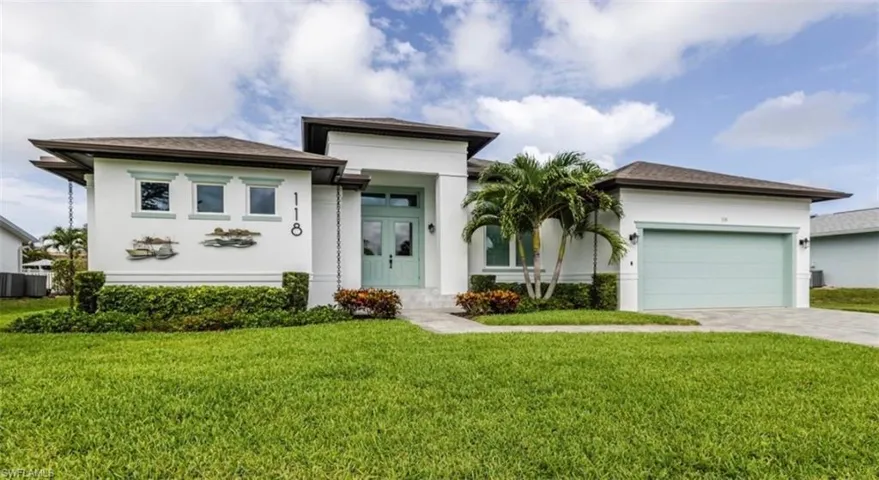 MODERN style home with French front doors, a 2 CAR attached garage and a paver driveway