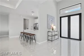 Entrance foyer with tile flooring and french doors