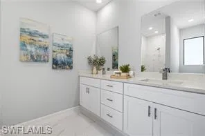 Bathroom featuring tile flooring and dual bowl vanity