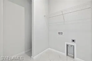 Laundry area featuring tile floors, hookup for an electric dryer, and washer hookup