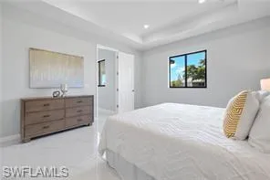 Bedroom with a raised ceiling