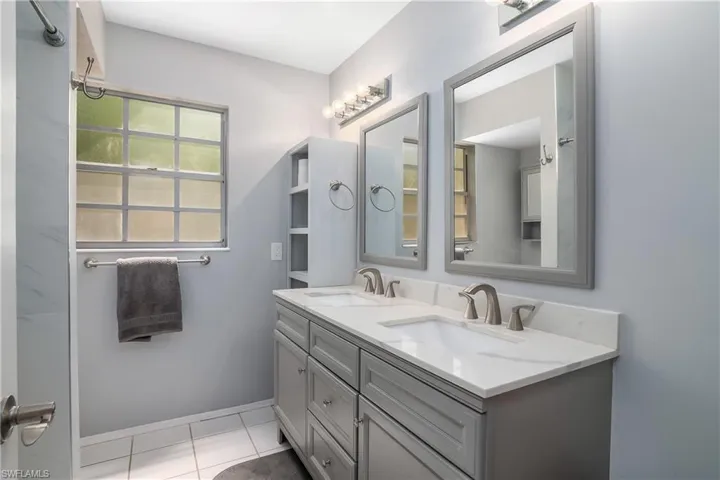 Owner bath includes dual sinks and a walk-in shower.