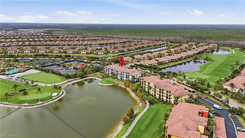 Aerial view of property's location featuring a golf club, a nearby body of water, and nearby suburban area