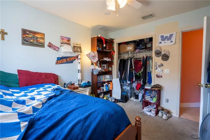 Bedroom featuring carpet, a closet, visible vents, a ceiling fan, and baseboards