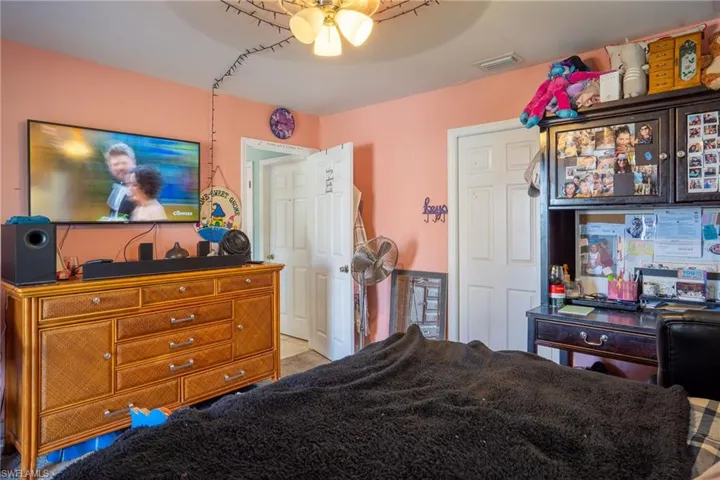 Bedroom featuring a ceiling fan and visible vents