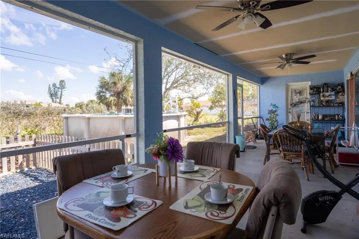 Sunroom featuring a ceiling fan