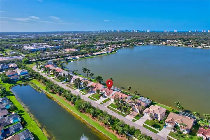 Birds eye view of property with a water view