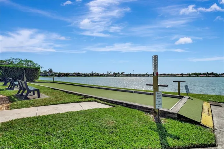 View of dock featuring a yard and a water view