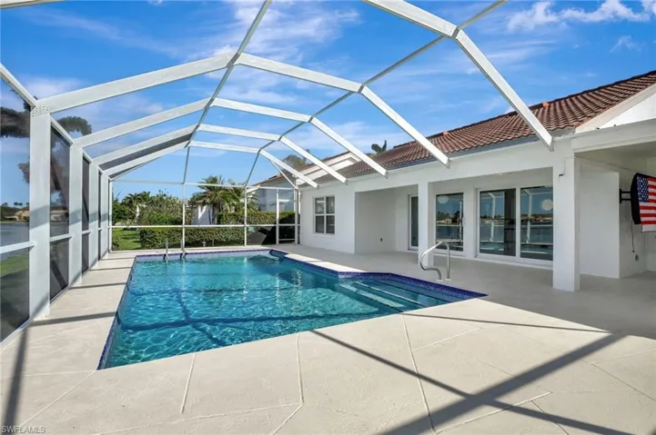 View of swimming pool featuring a patio and a lanai