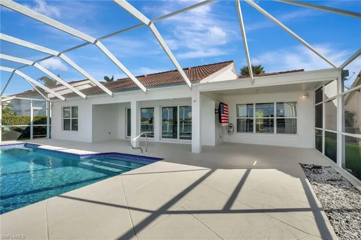 View of swimming pool with a lanai and a patio area