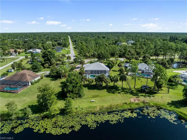 Birds eye view of property with a water view
