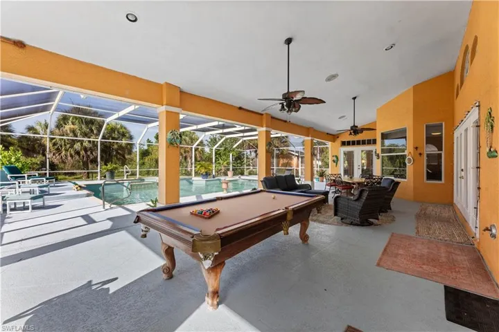 Playroom featuring ceiling fan, lofted ceiling, and pool table