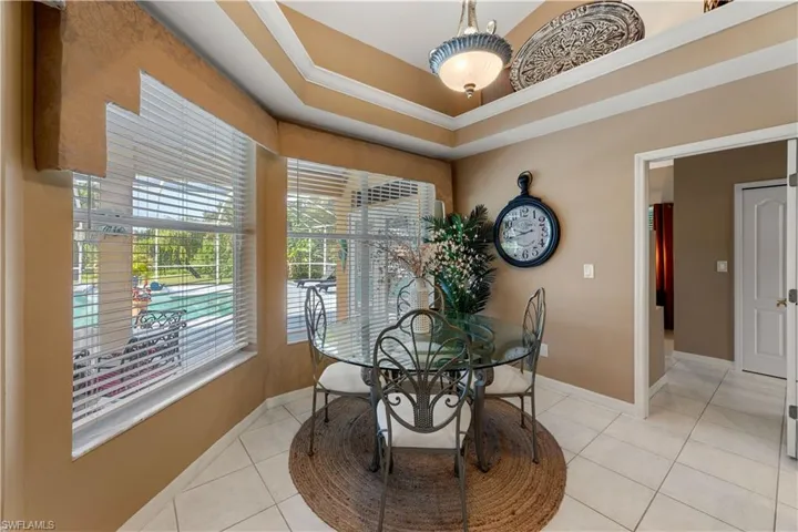 Dining area with light tile patterned floors