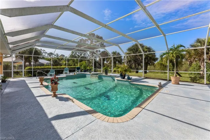 View of swimming pool featuring a lanai and a patio area
