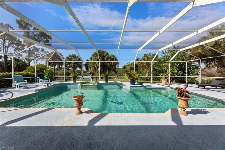 View of swimming pool with a patio area and a lanai