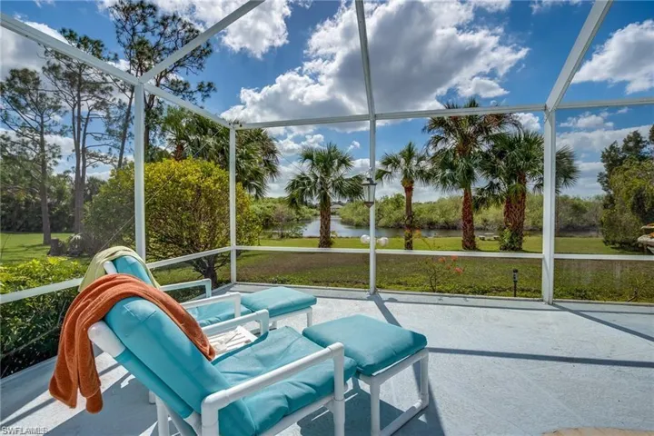 Sunroom / solarium featuring a water view