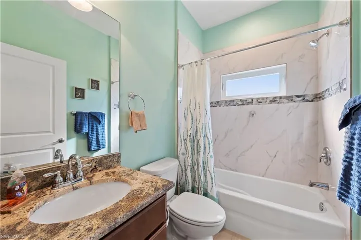 Bathroom with shower / bath combo and vanity