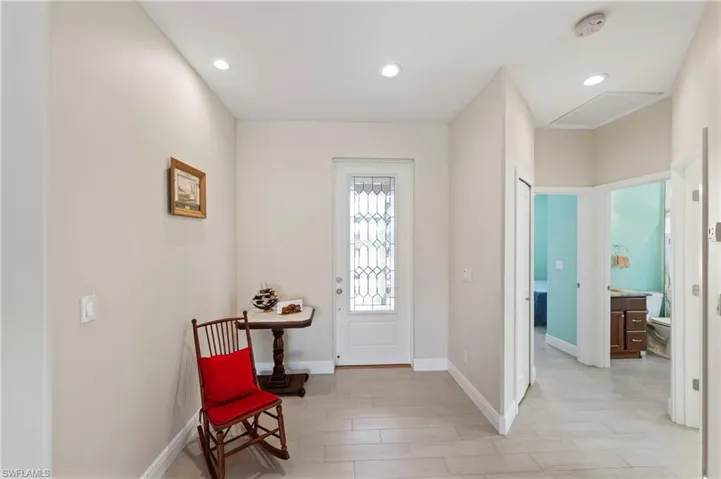 Entrance foyer with recessed lighting and wood tiled floors