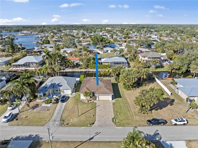 Aerial view of property's location featuring nearby suburban area and a large body of water