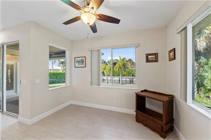 Spare room with a ceiling fan and baseboards