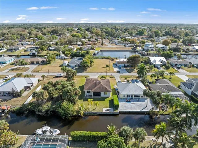 Aerial view of residential area featuring a nearby body of water