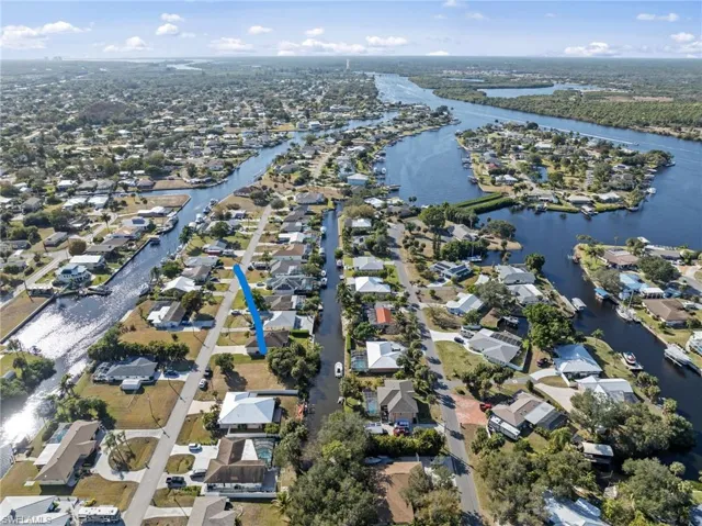 Aerial overview of property's location featuring nearby suburban area and a large body of water