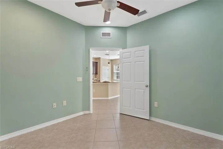 Den/Office Tile flooring and a ceiling fan with integrated lighting