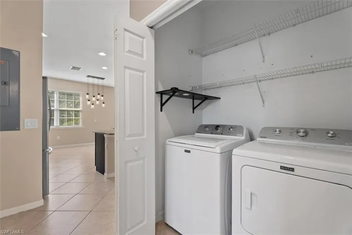Laundry closet with wire shelving and a wall-mounted folding shelf