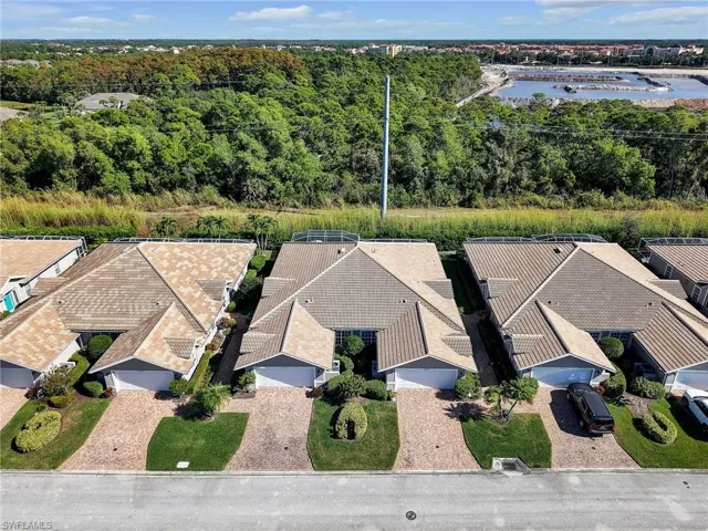 Aerial perspective of suburban area featuring a nearby body of water