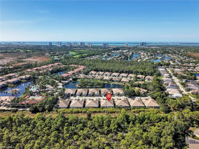 Aerial perspective of suburban area with a nearby body of water