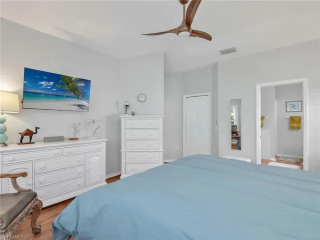 Bedroom featuring wood finished floors, a ceiling fan, and a closet