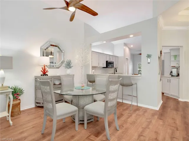 Dining area featuring a ceiling fan, light wood finished floors, lofted ceiling, and recessed lighting