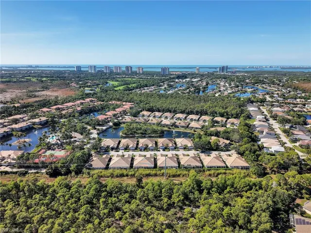 Aerial perspective of suburban area featuring a nearby body of water