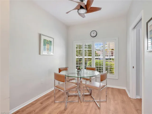 Dining area with a ceiling fan and light wood finished floors