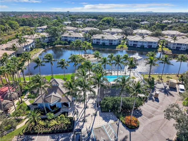 Aerial perspective of suburban area featuring a large body of water and a pool