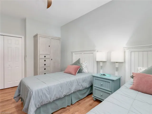 Bedroom with a closet, light wood-type flooring, and ceiling fan
